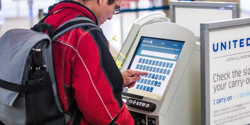 Man using airline check-in kiosk
